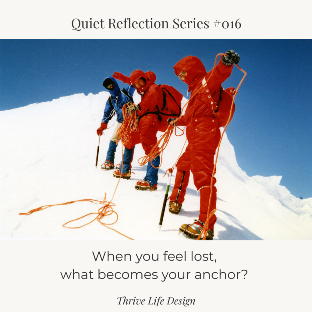 Mountain climbers walking in a line along a snowy slope, linked by a rope.